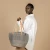 mifuko-sisal-shopper-basket-Kiondo light grey M model in studio.webp